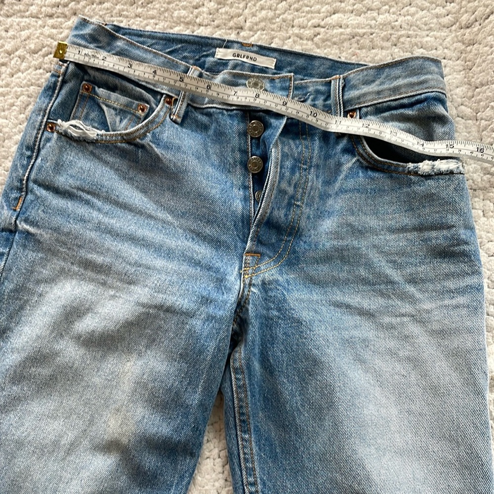 24 Helena grlfrnd jeans distressed at knees.